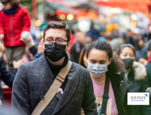 crowd of people wearing masks walking on the street