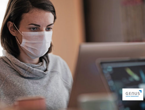 woman standing in front of laptop with facemask on