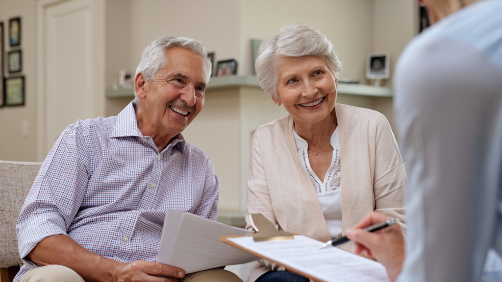 Elderly couple with a portfolio manager going over their financial plan