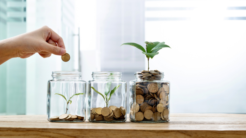 hand putting coins in a jar to diversify a portfolio