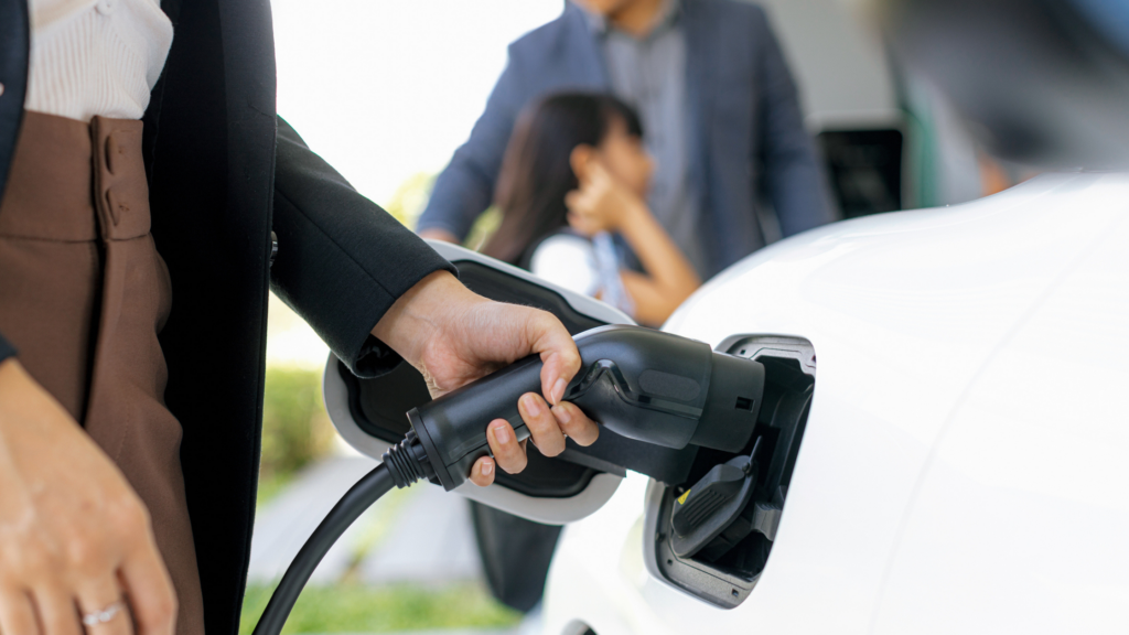 woman charging an electric car